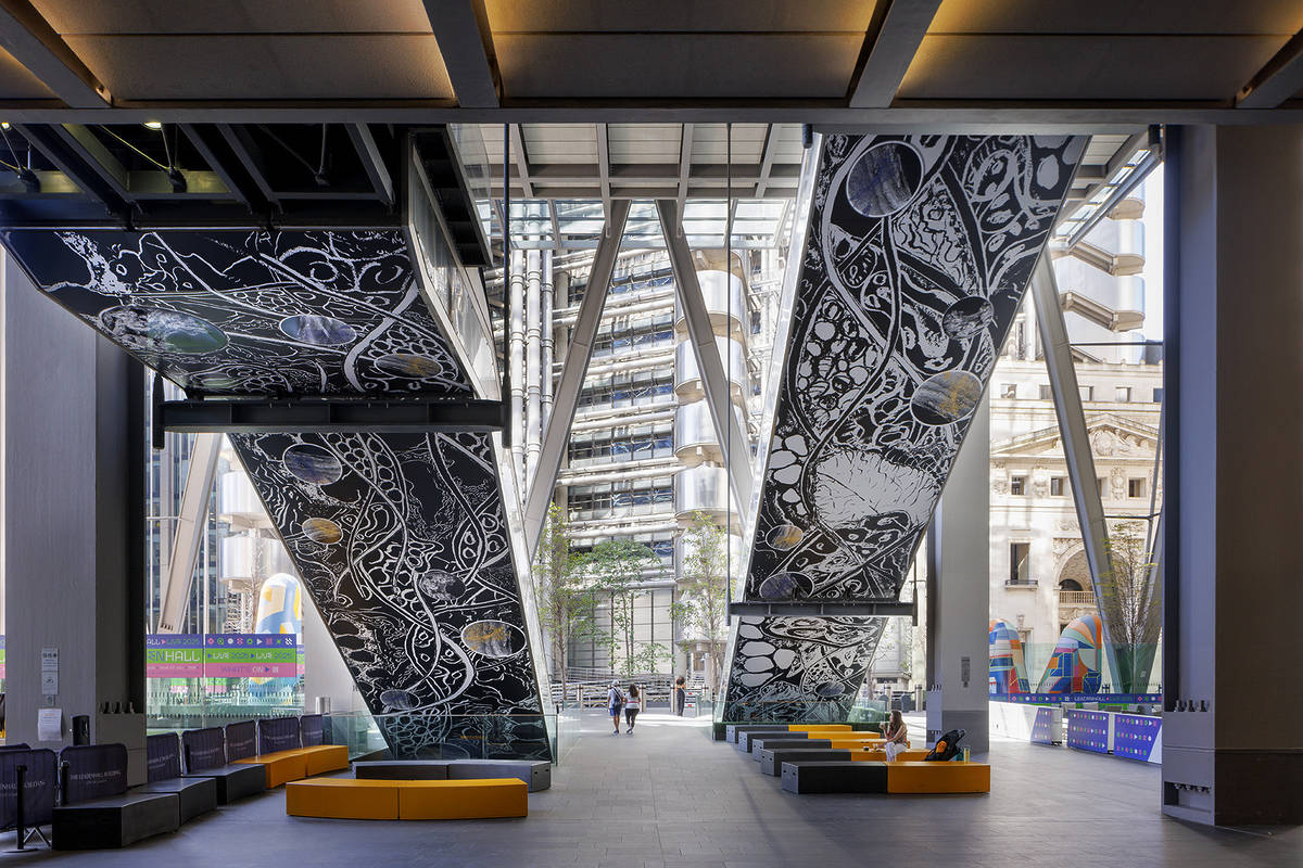 the underside of two escalators in london covered by sprawling microscopic artwork