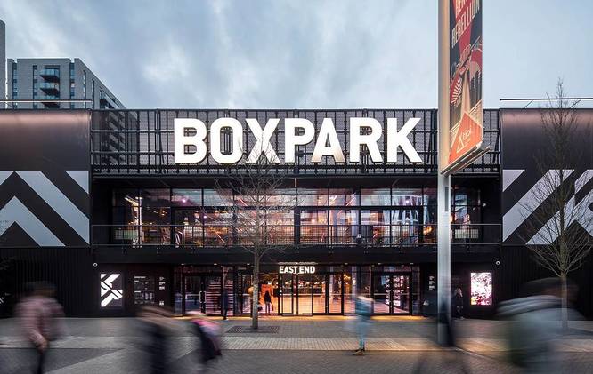 Shot of Boxpark Wembley with a flag on Wembley Way