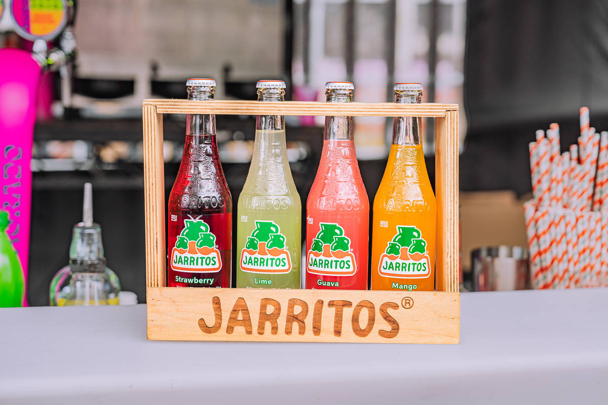 bottles of jarritos soda in a wooden stand