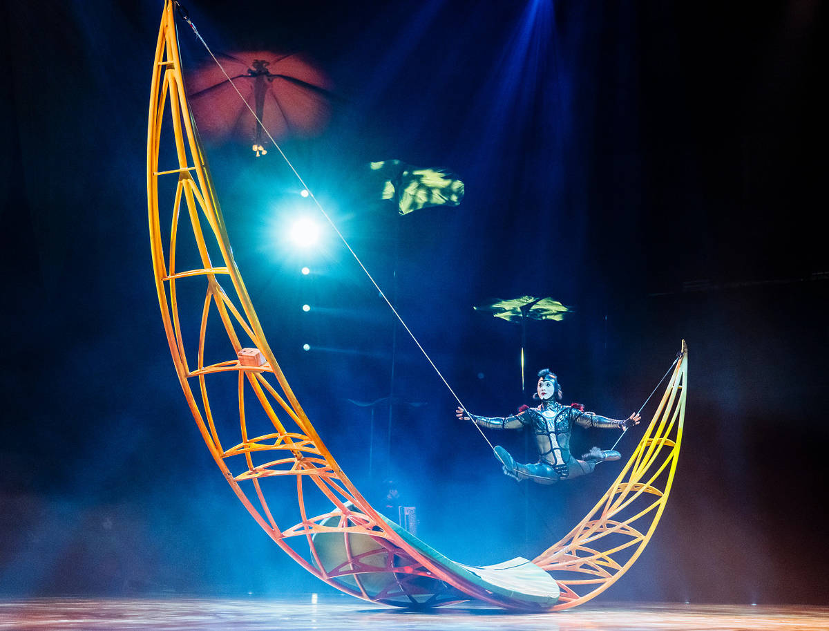 Circus performer on a moon-shaped balance beam during 'Ovo' by Cirque du Soleil.
