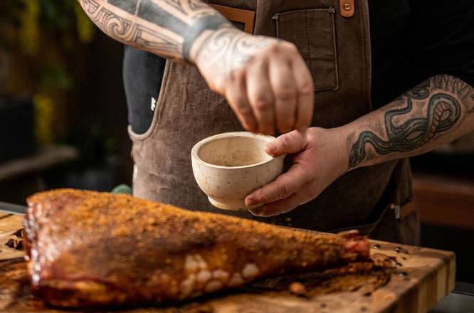 Meat being seasoned by chef Matt Austin