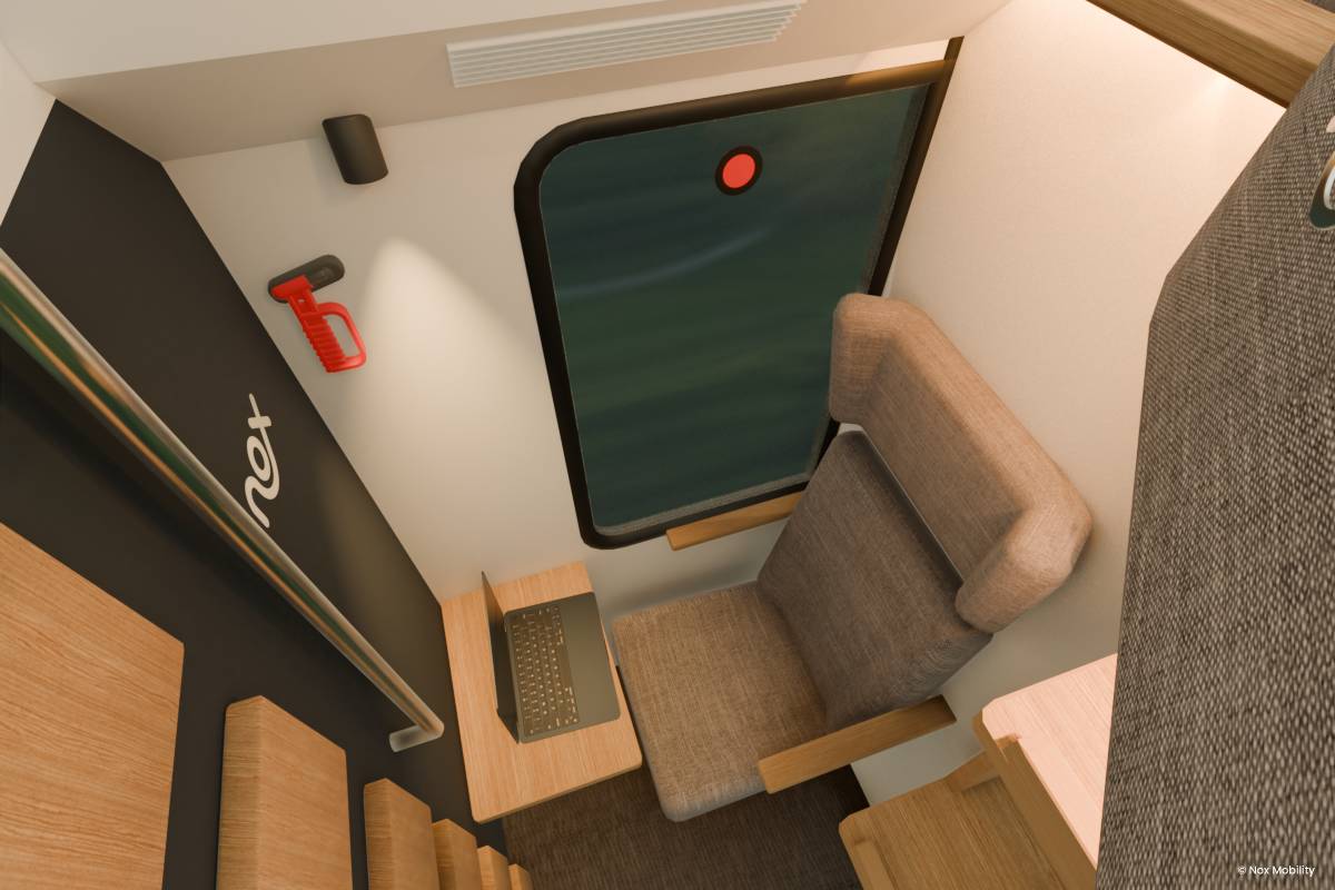 A mock up of what a cabin inside the new nox sleeper trains with a bunk bed and a vew out onto some trees at nighttime