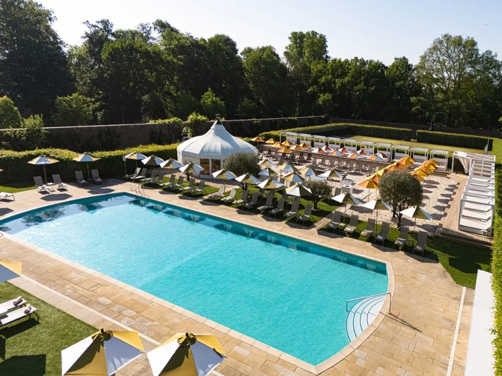 a swimming pool surrounded by deck chairs