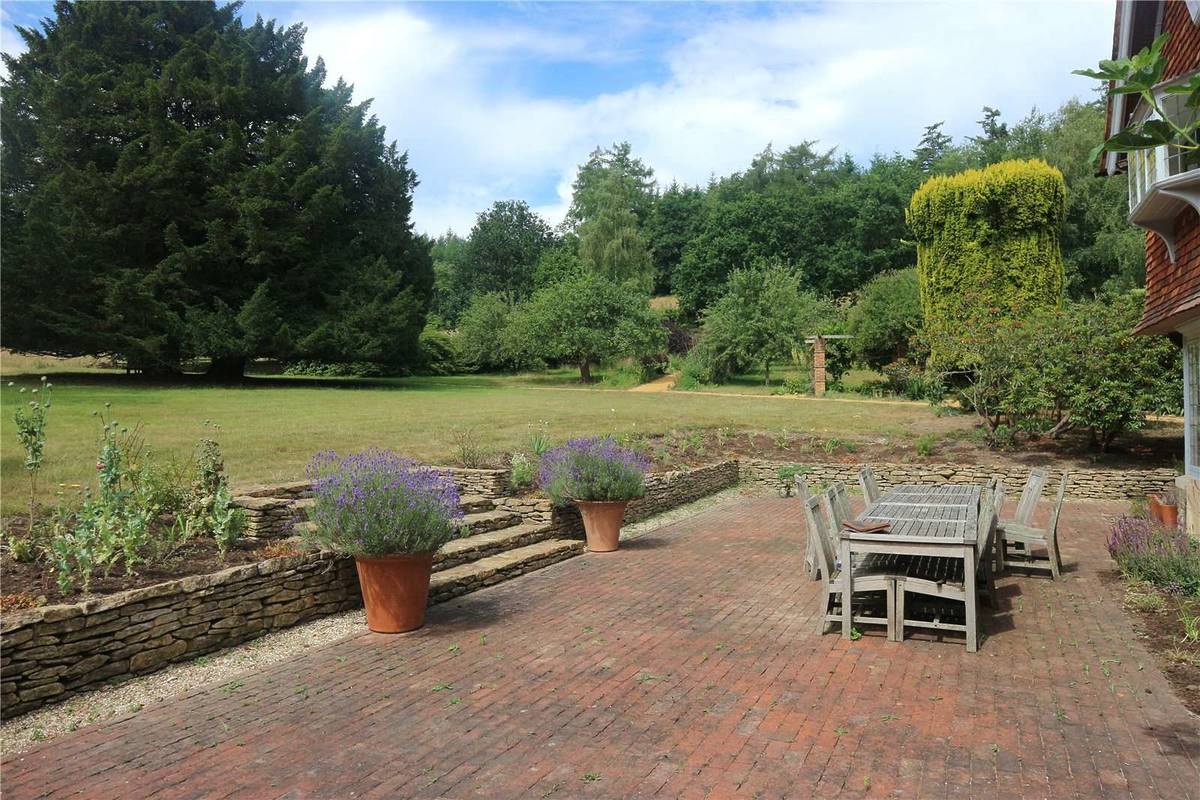 The ladscaped gardens of a farmhouse in Surrey
