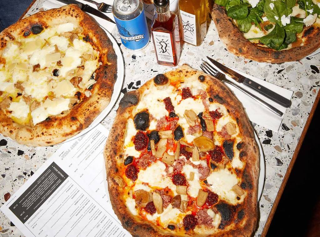 Shot of pizzas from Santa Maria displayed across a table
