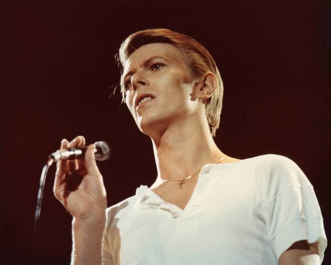 David Bowie performing on stage.