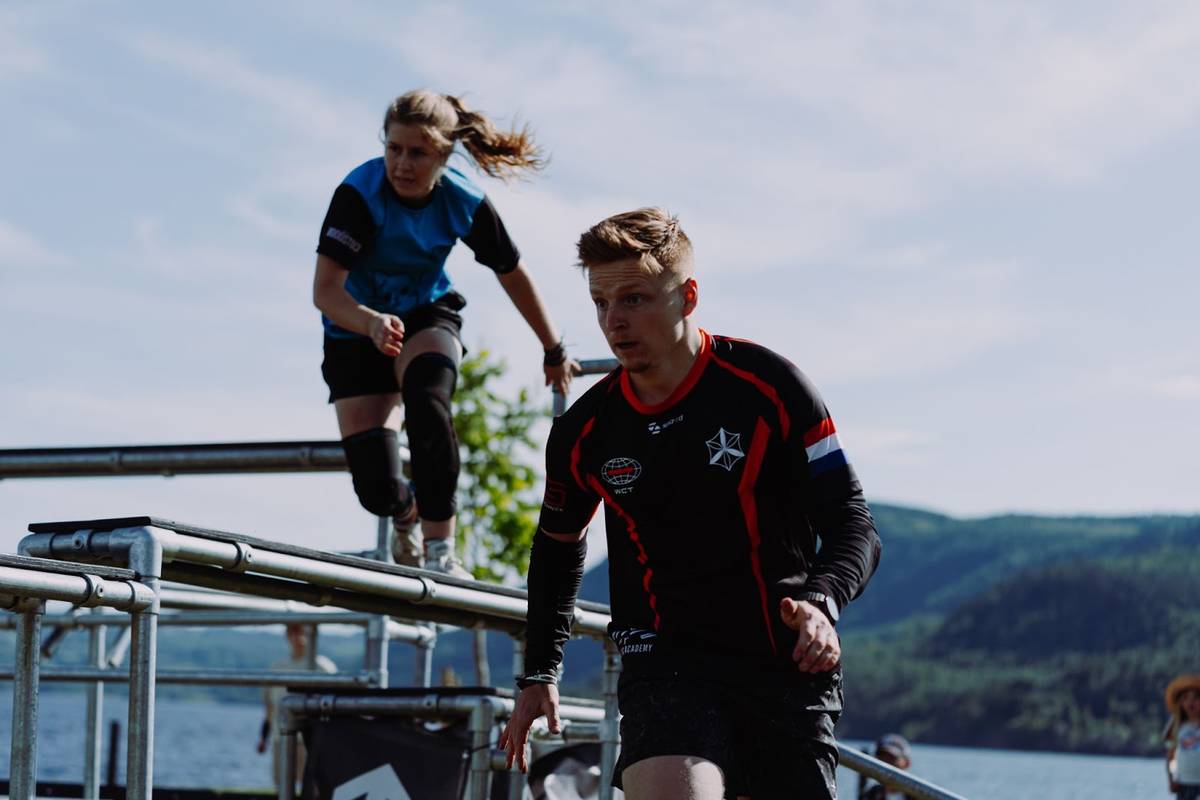 a man and women playing chase tag outside