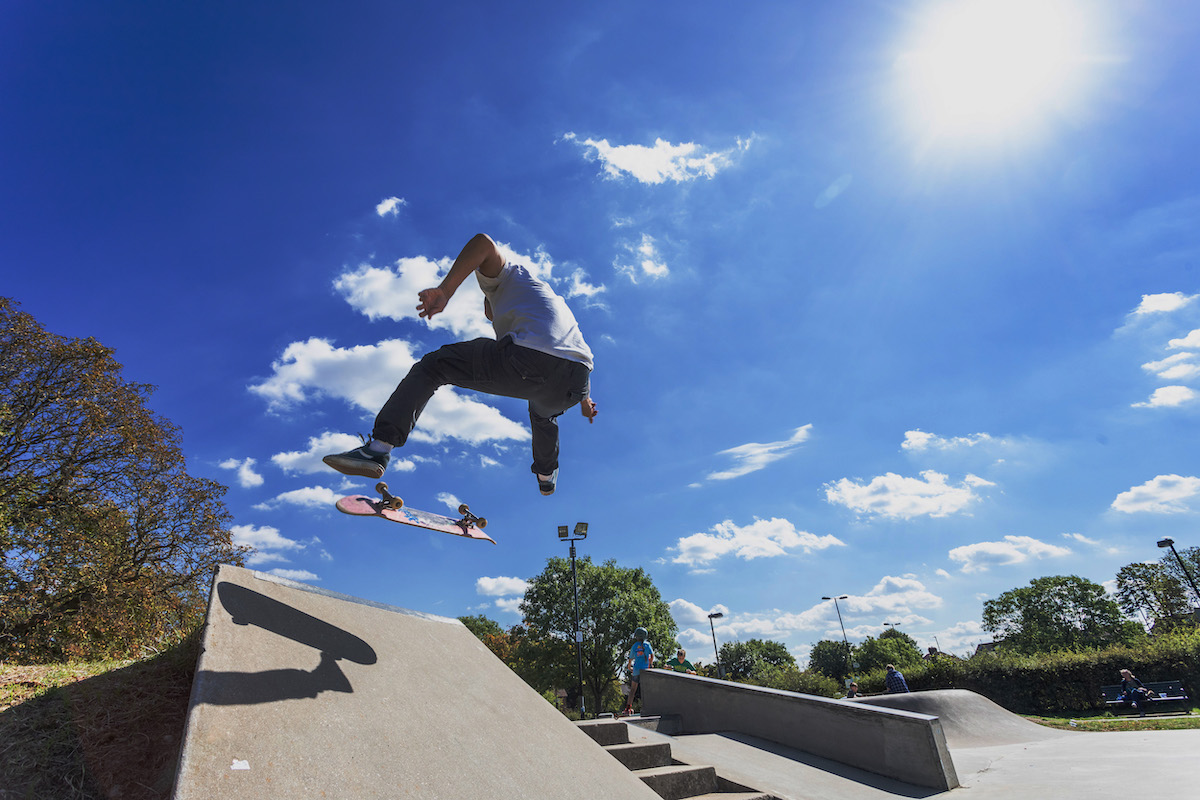 a skater completes a trick in a skate park in brent cross town