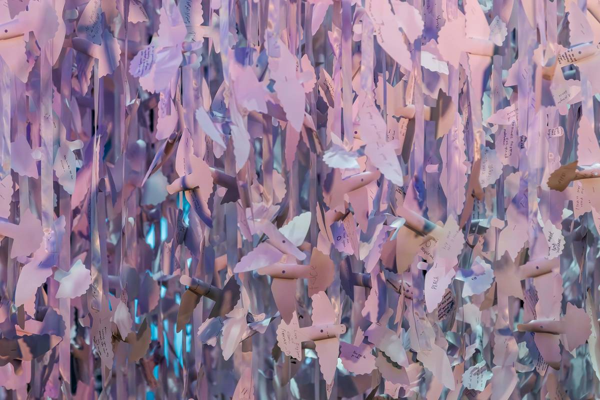 paper doves suspended from the ceiling of a cathedral