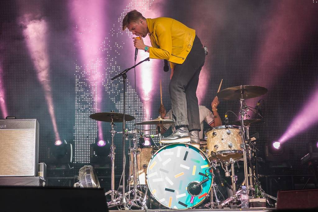 Kaiser Chiefs frontman Ricky Wilson standing on a drum