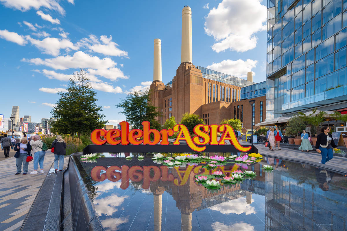 a colourful sign reading 'celebrASIA' with the battersea power station visible in the background
