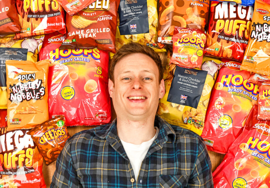 Aldi Chief Crisp Tasting Officer George Critchley with a range of Aldi own brand crisps.