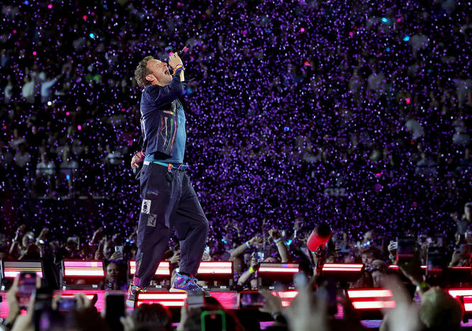 Chris Martin of Coldplay singing on stage during the Music For The Spheres Tour
