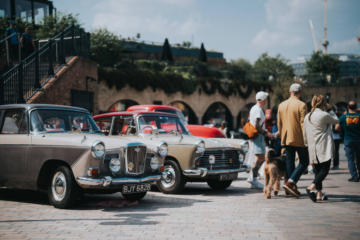 people walking past classic cars at the classic car boot sale