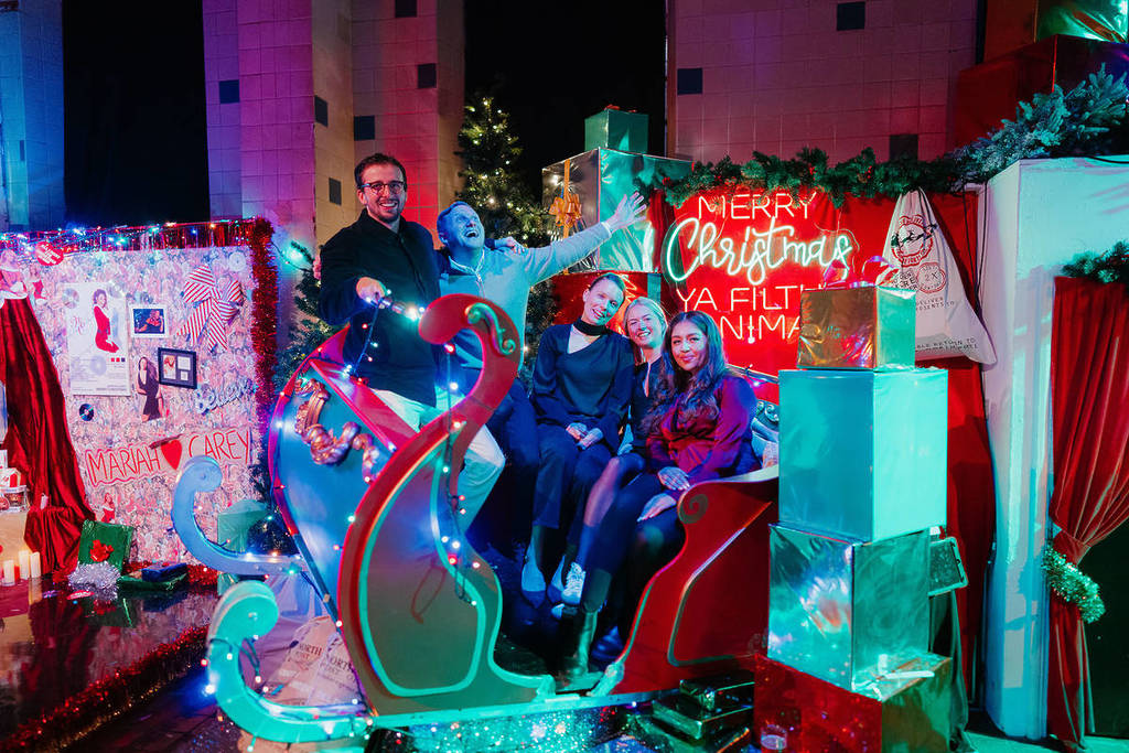 a group of people cheer in a sleigh at HUMBUG