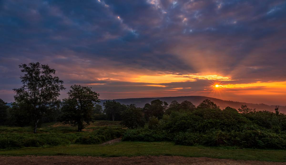 A dramatic sunrise across the Surrey Hills from on top of Holmbury Hill