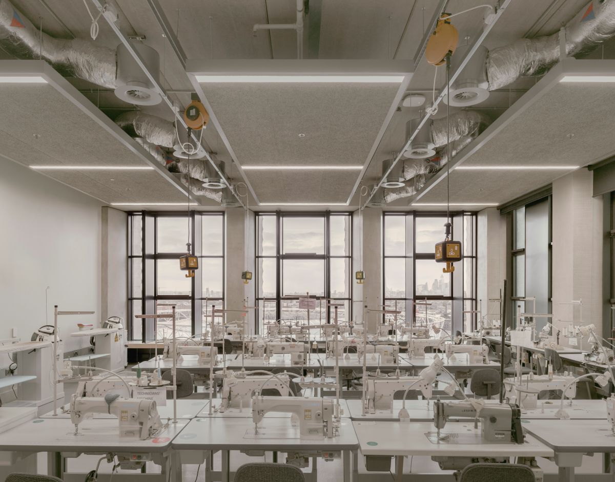 The inside of the London College of Fashion with lots of desks with sewing machines on