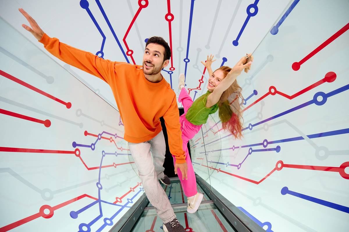 Couple enjoying the rotating tunnel at the Paradox Museum in Knightsbridge, London.