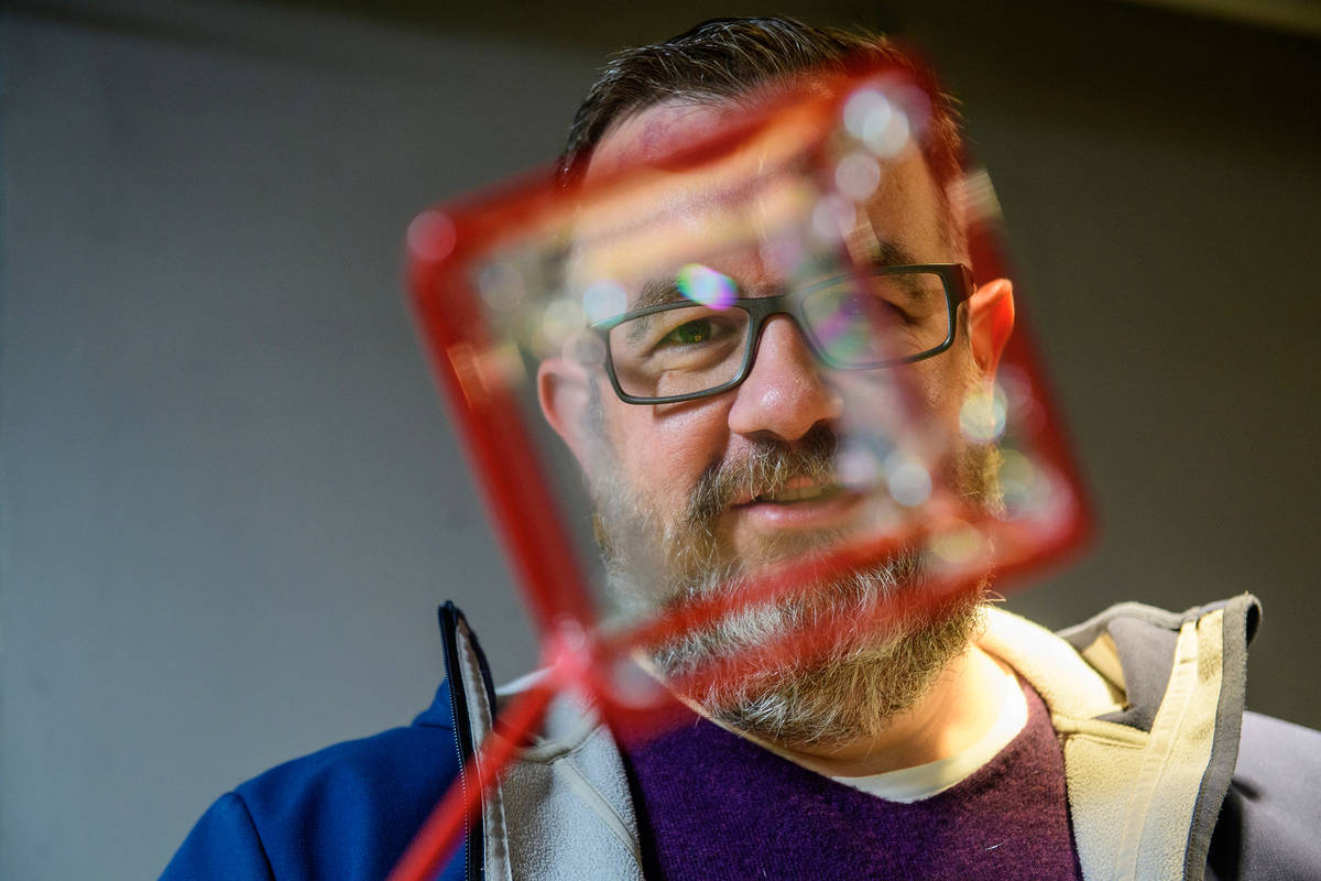 someone peering through a prism into the camera