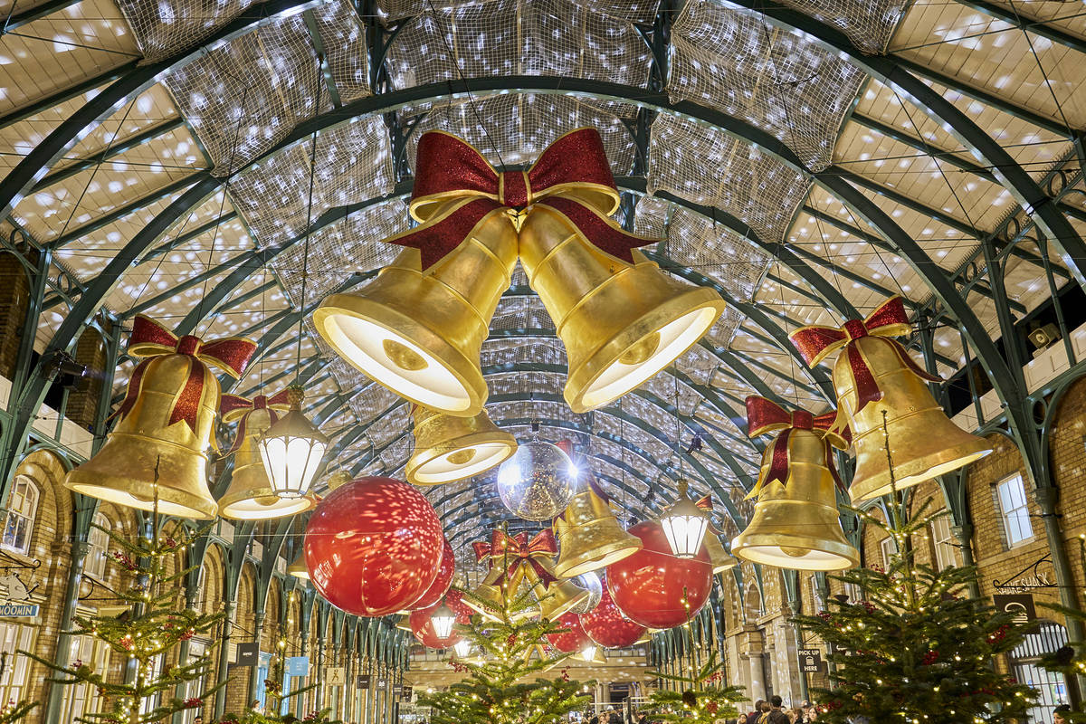 golden bells and hundreds of fairy lights illuminating covent garden's market place