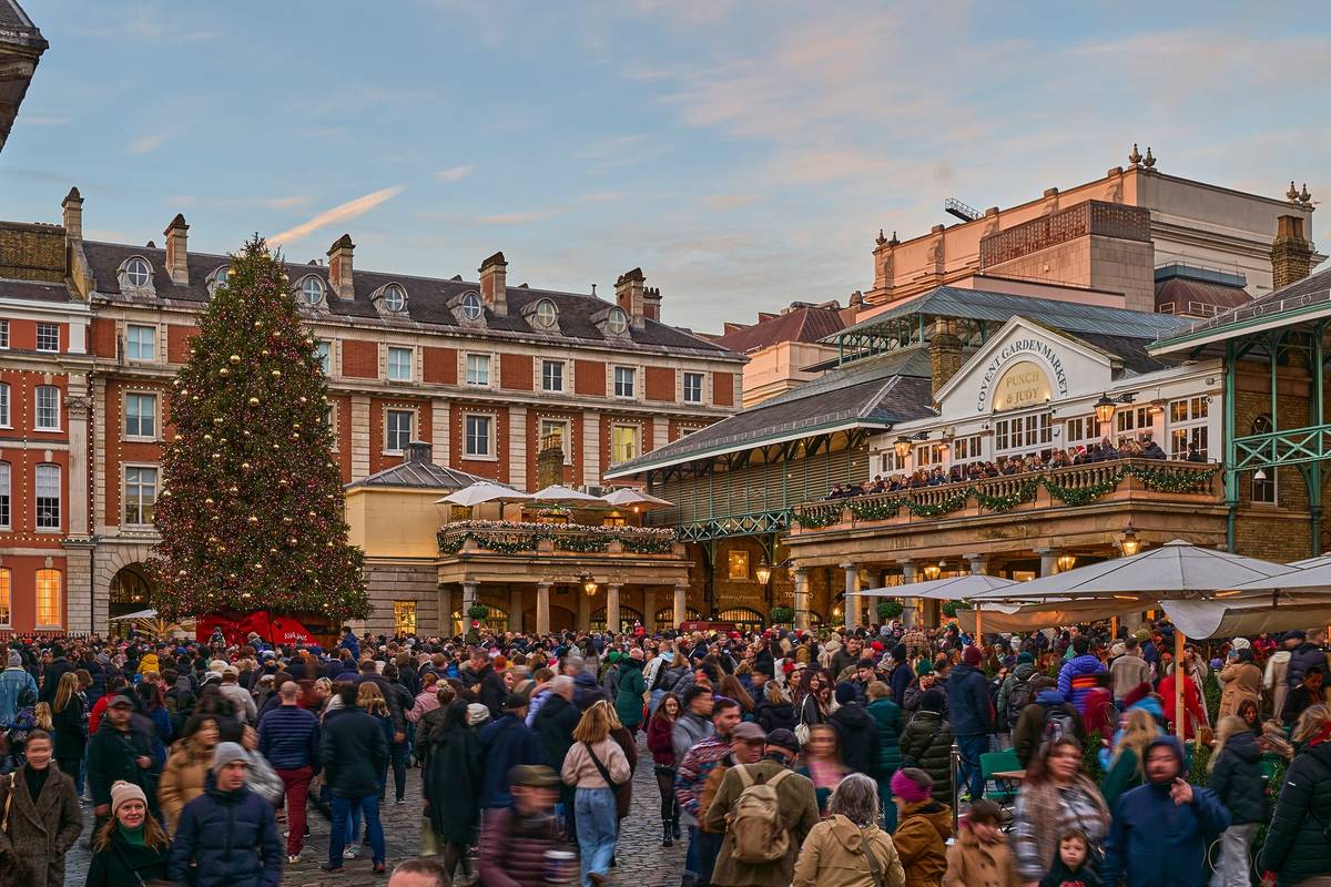 people milling about covent garden enjoying the christmas decorations
