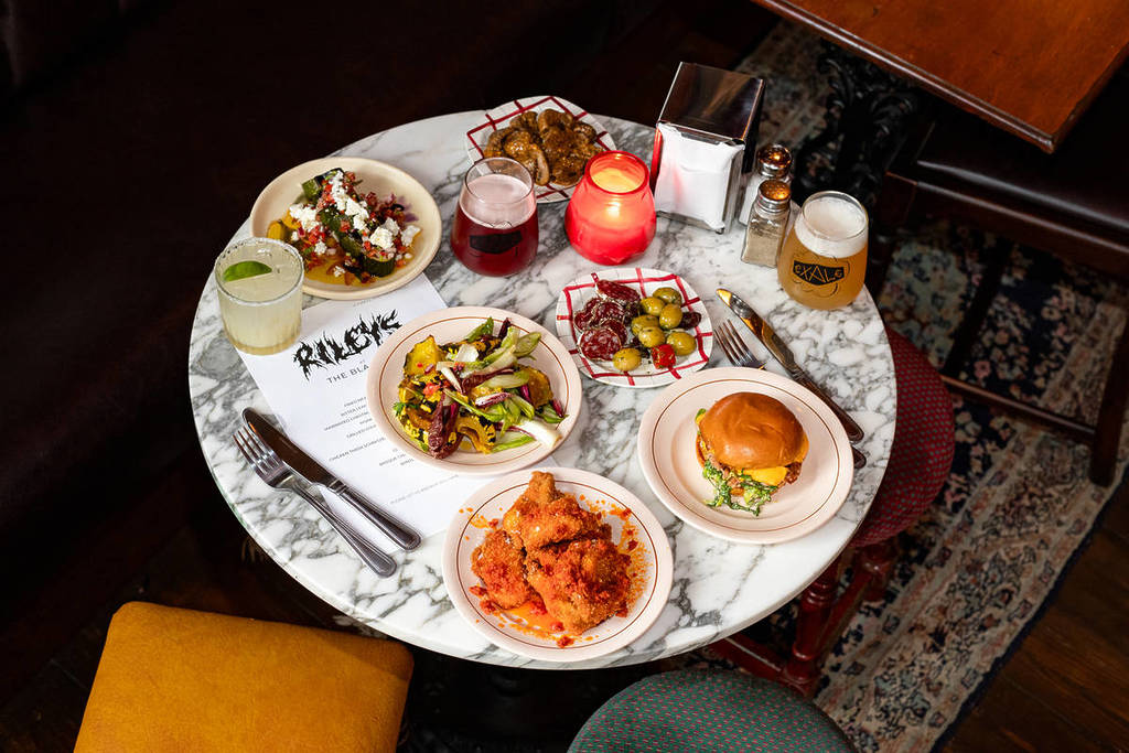 A table full of food and drink that will be served at the new Black Eel pub