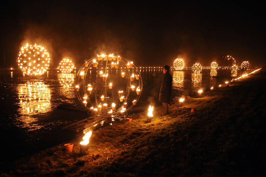 fire lighting up the water and land at a large fire installation