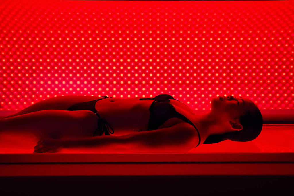 a woman doing red light therapy at the third space recovery spa