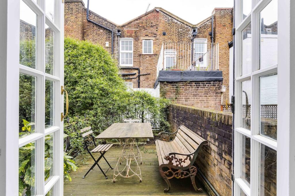 A terrace garden with an outdoor table and chairs