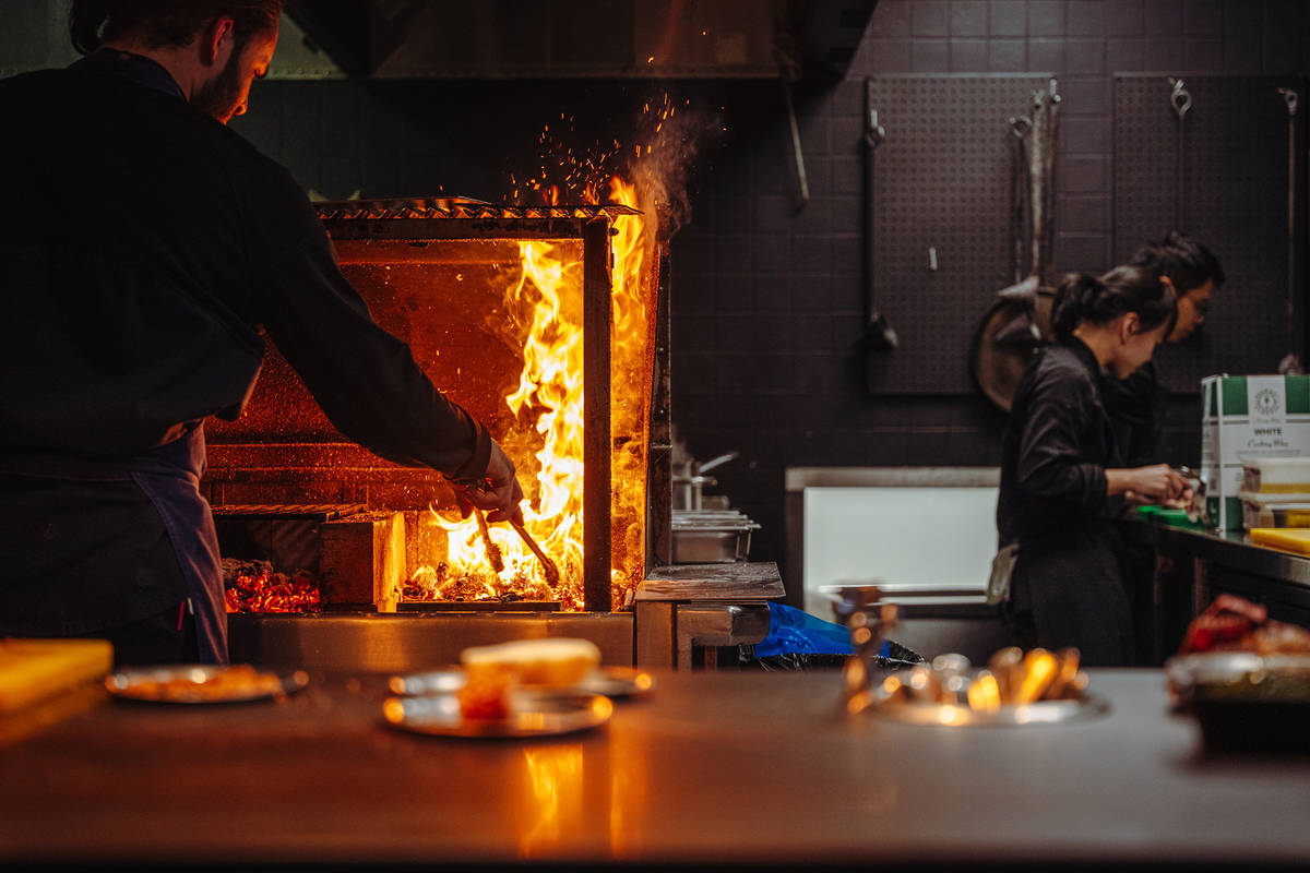 a kitchen where cooks are cooking with live fire