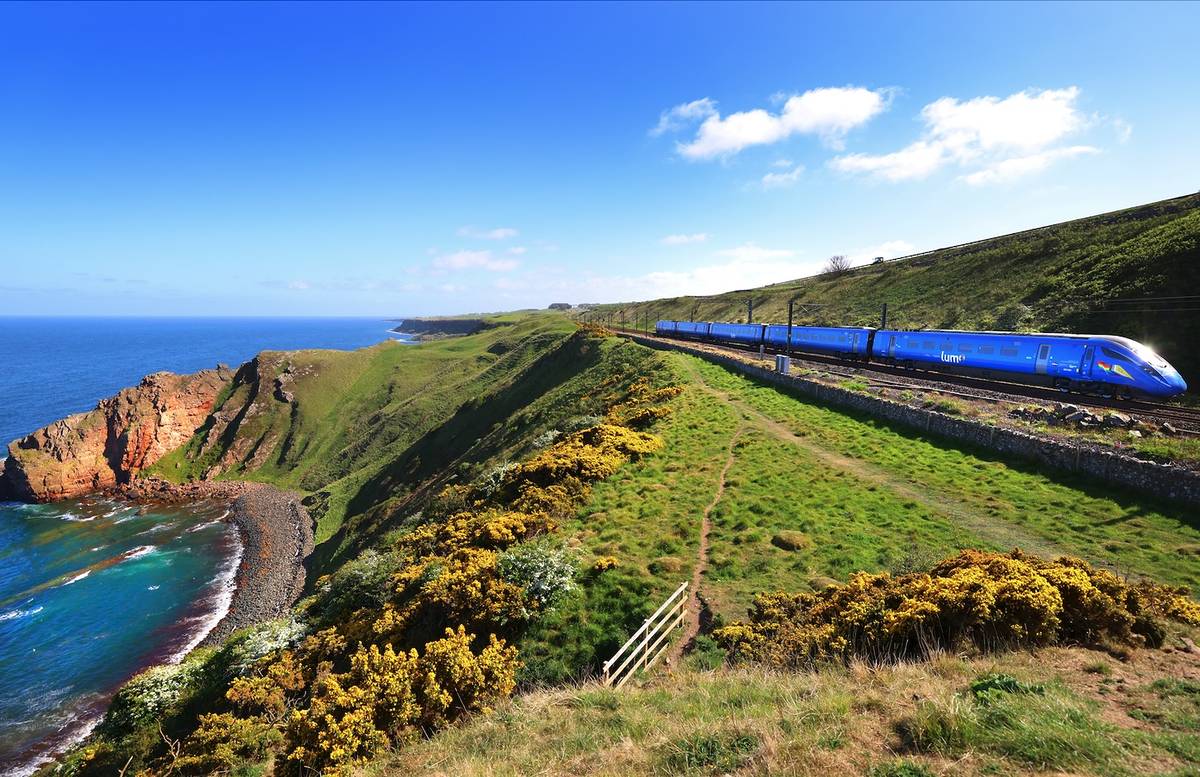 a lumo train travelling through Scotland