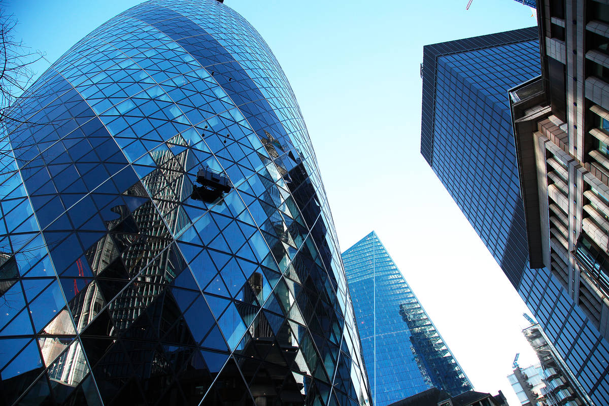 the Gherkin and other buildings in London as seen from the street