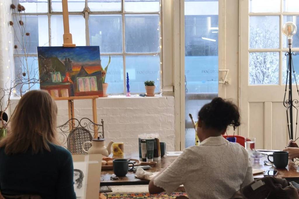 Zwei Menschen von hinten gesehen während einer Malsitzung