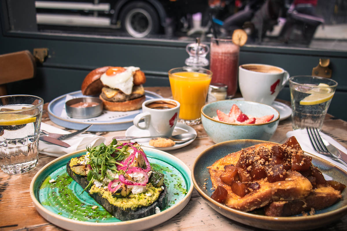 a selection of breakfast and brunch dishes arranged on a pub table