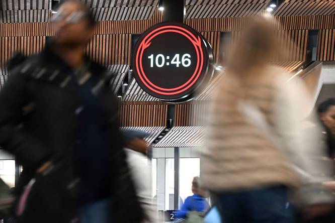 The new Network Rail clock at London Bridge station as commuters walk past