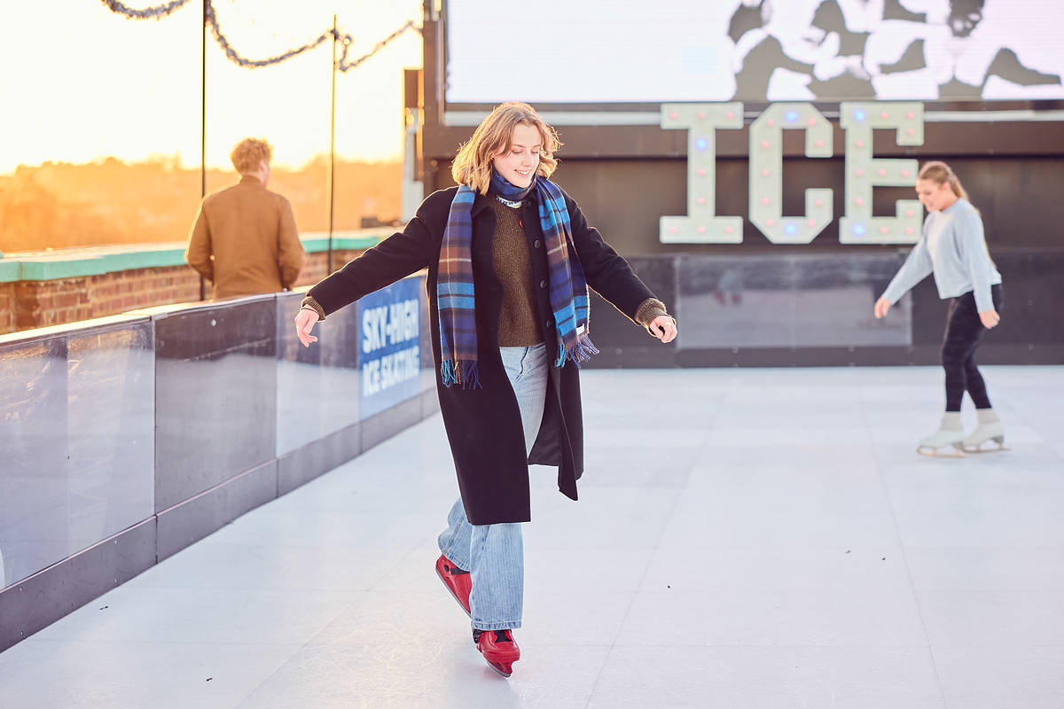 someone skating along the ice on an ice rink