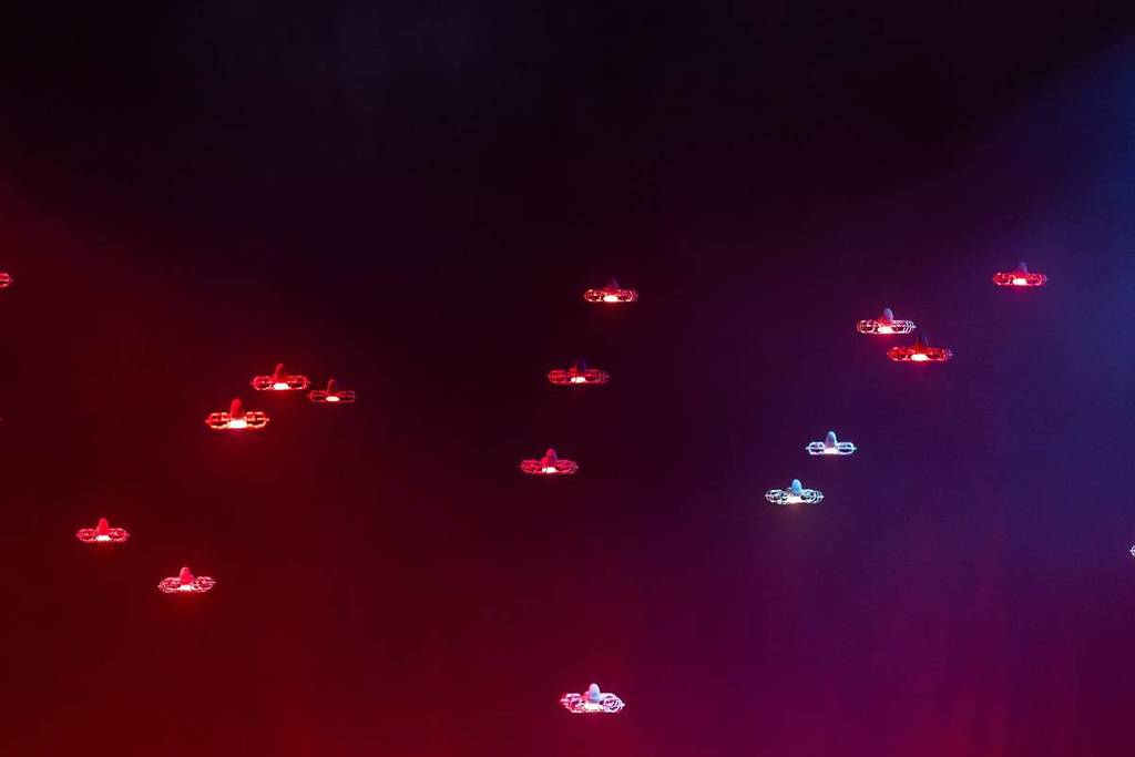 A red sky filled with red and blue drones at Dance of Drones.