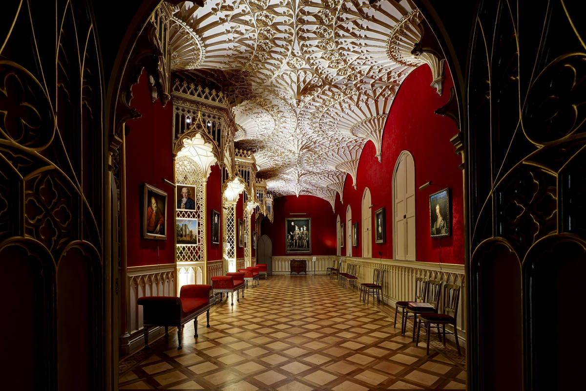 the opulently decorated interiors of strawberry hill house featuring red walls, gold accents, and a geographic pattern on the ceiling