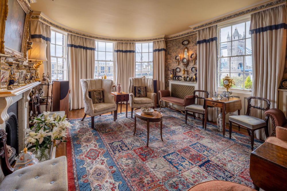 The drawing room inside a Riverside property with a view of Tower Bridge through the window