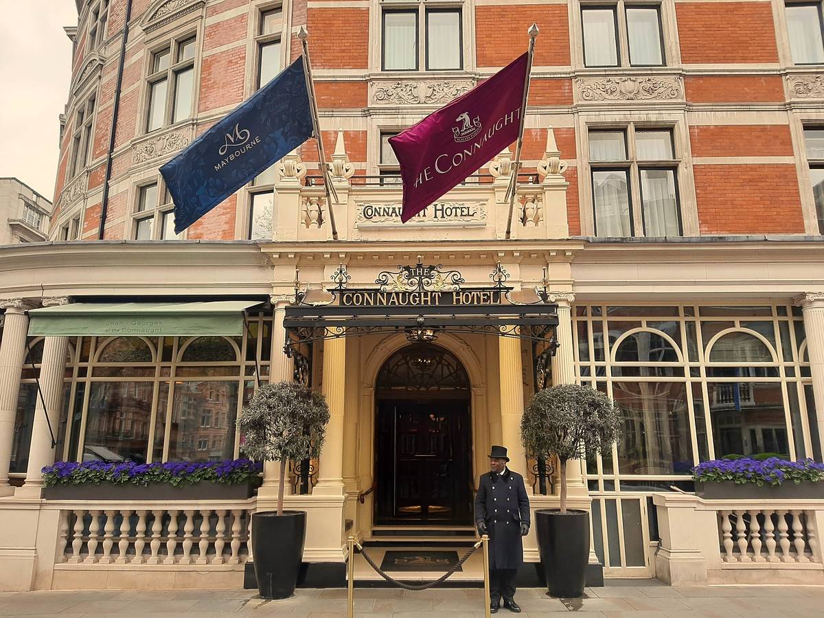 A doorman stood outside the front entrance of The Connaught hotel