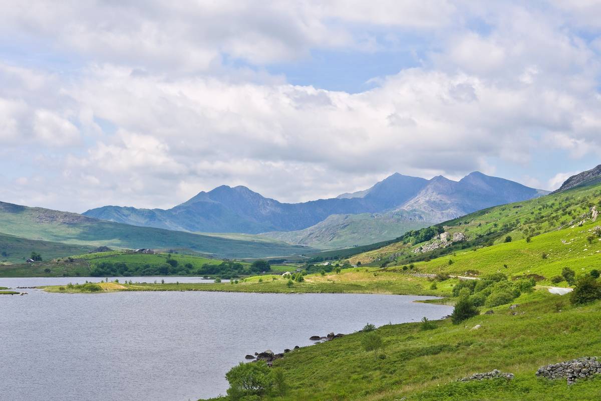 Snowdon, the highest of the Welsh mountains, from a viewpoint beside the Llynnau Mymbyr lakes in the peaceful green valley of Dyffryn Mymbyr, near Capel Curig, Conwy, north Wales.