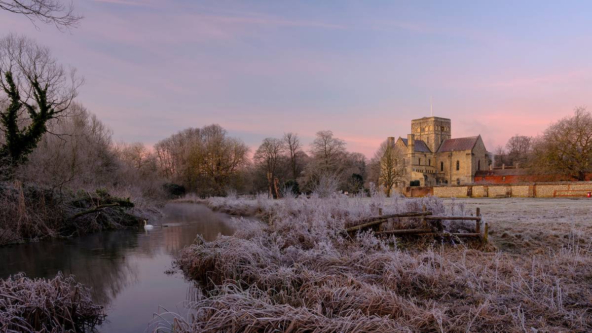 Frosty winter sunrise with a hoarfrost view of St Cross Hospital, Winchester, Hampshire, UK