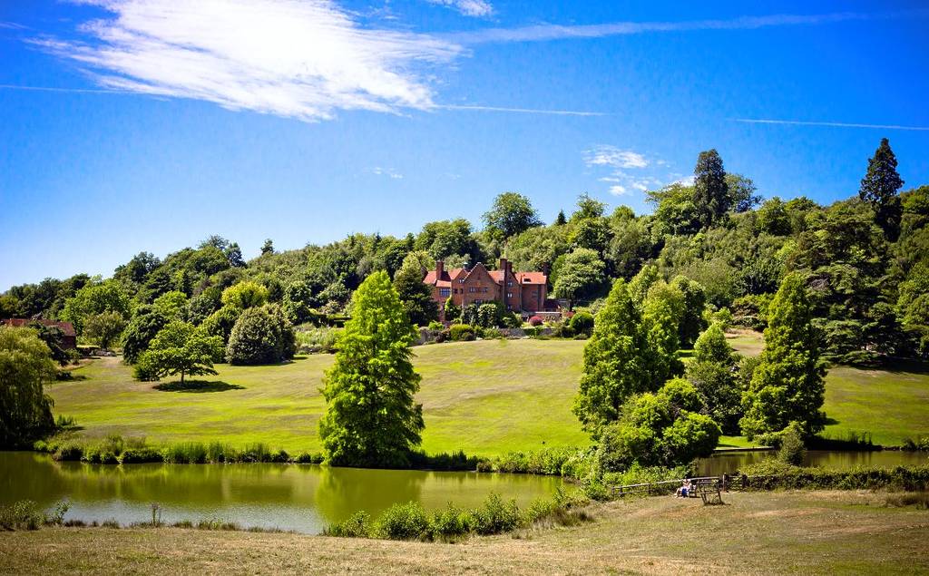 A stately home set in the middle of picturesque green gardens