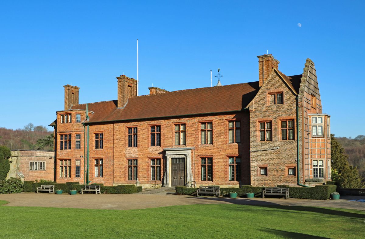 A stately home under a bright blue sky