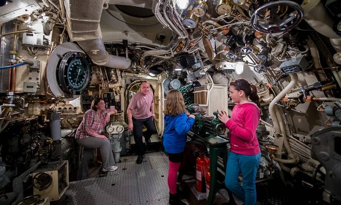 Visitors at Portsmouth Historic Dockyard, exploring the engine room