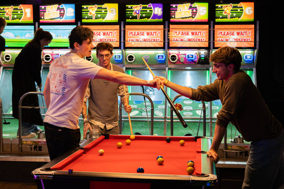 People playing pool at the arcade at The Thieves pub and playhouse in Battersea, London.