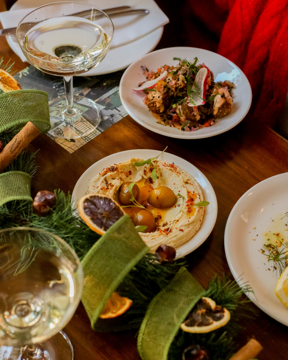 platters of hot and cold meze scattered around christmas decorations