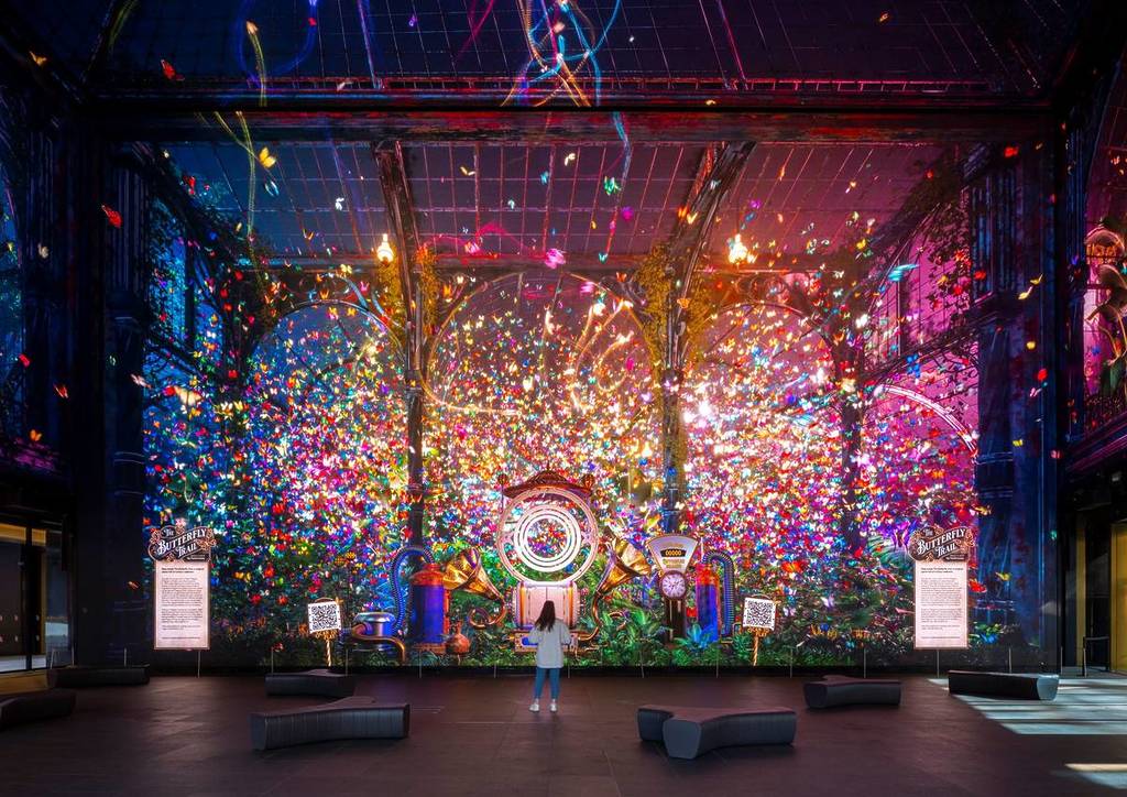 A colourful display of digital butterflies on the huge floor to ceiling screens at Outernet