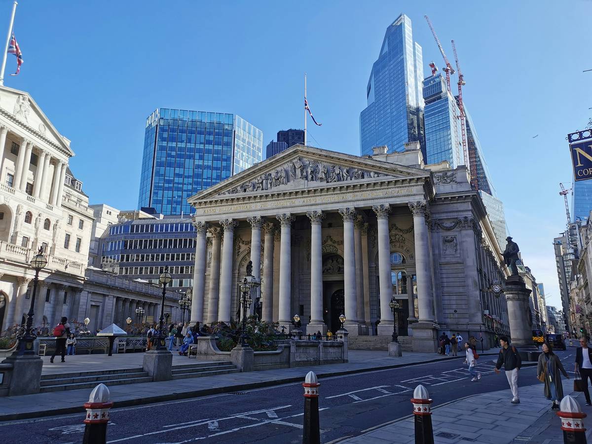 The bank of England perched infront of various skyscrapers in the city of London