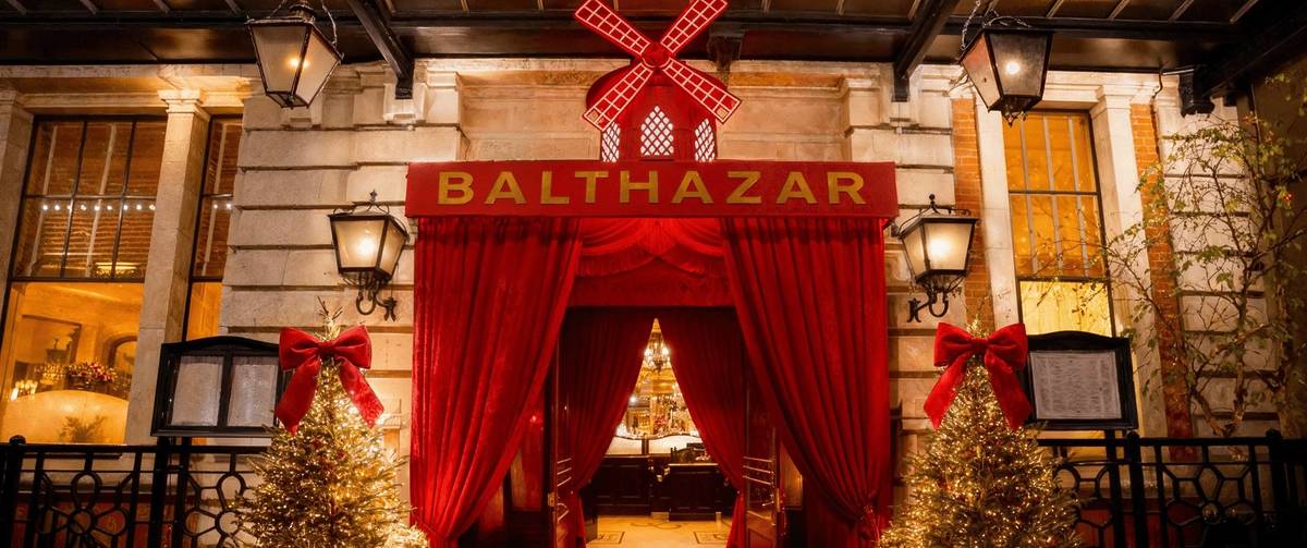 the entrance to balthazar restaurant, flanked by opulent red curtains